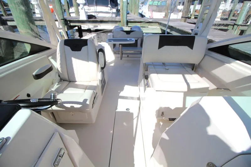 Slide: The Image of 2023 Sailfish 276 DC boat interior with white seating and modern design. - 15