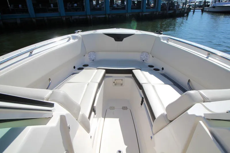 Slide: The Image of 2023 Sailfish 276 DC boat interior with white seating and waterfront view. - 16