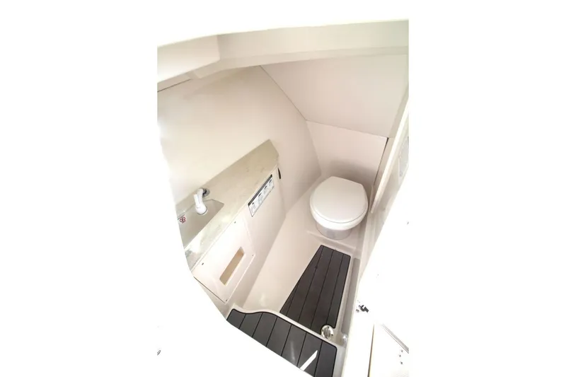 Slide: The Image of 2023 Sailfish 276 DC boat interior bathroom with toilet and sink. - 18