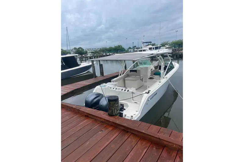 Slide: The Image of 2023 Sailfish 276 DC boat docked with twin engines, aerial view. - 2