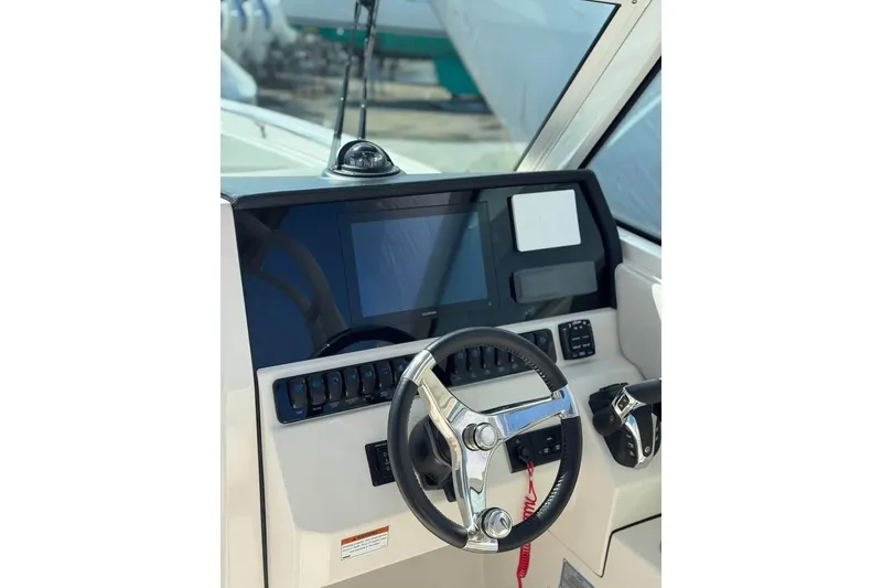 Slide: The Image of 2023 Sailfish 276 DC boat docked with Yamaha engines, featuring sleek design. - 3