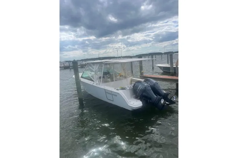 Slide: The Image of 2023 Sailfish 276 DC boat docked at marina, front view. - 5