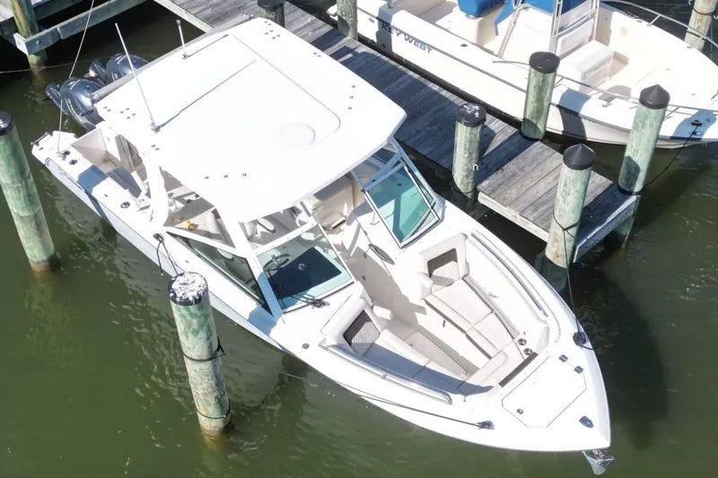 Slide: The Image of 2023 Sailfish 276 DC boat docked at marina, aerial view. - 7