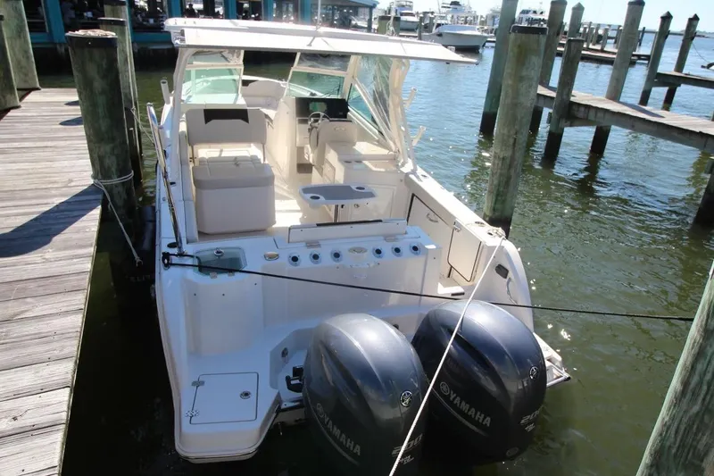 Slide: The Image of 2023 Sailfish 276 DC boat docked with dual Yamaha outboard engines. - 9