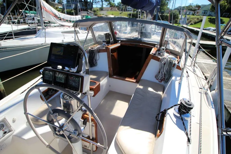 Slide: The Image of Cockpit of a 1988 Catalina 34 sailboat with steering wheel and navigation instruments. - 13