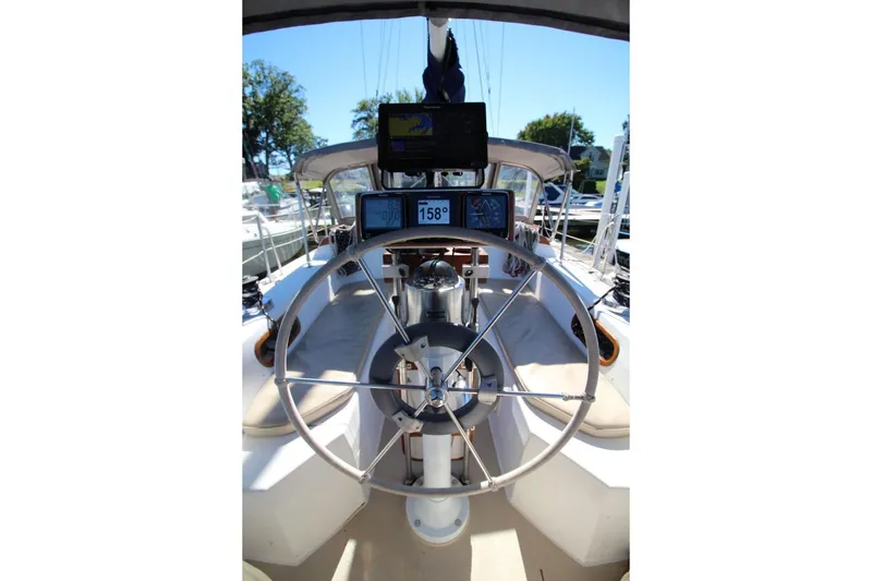 Slide: The Image of Cockpit of 1988 Catalina 34 sailboat with steering wheel and navigation instruments. - 14