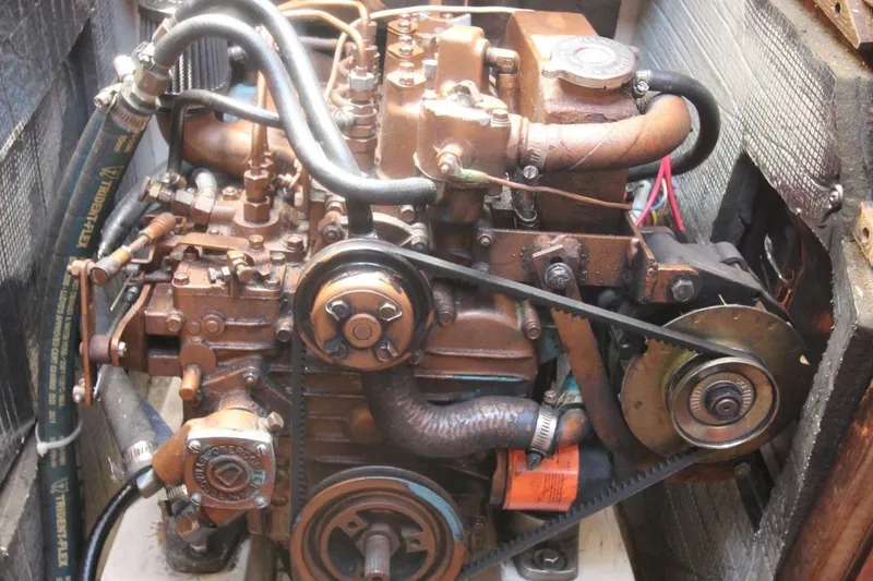 Slide: The Image of Engine of a 1988 Catalina 34 sailboat, showcasing mechanical components and belts. - 24