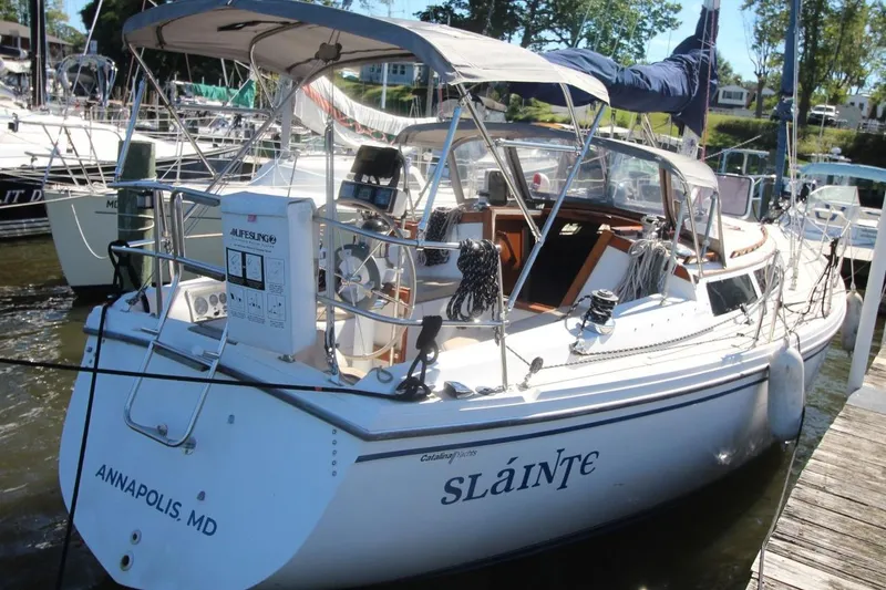 Slide: The Image of 1988 Catalina 34 sailboat docked in Annapolis, Maryland, with canopy and nautical equipment. - 3