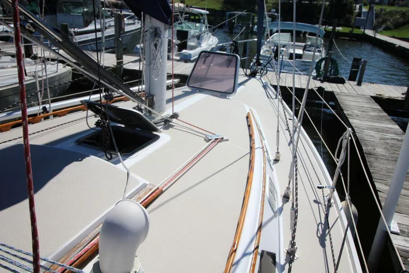Slide: The Image of 1988 Catalina 34 sailboat deck with rigging, docked at marina. - 9