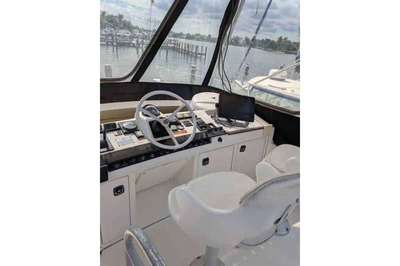 Slide: The Image of 1992 Luhrs Tournament 320 Convertible helm with steering wheel and navigation equipment. - 12