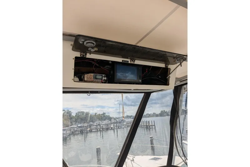 Slide: The Image of 1992 Luhrs Tournament 320 Convertible helm electronics with marina view. - 15