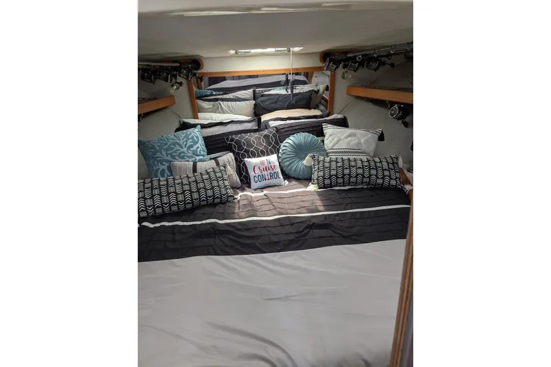 Slide: The Image of Cozy cabin interior of 1992 Luhrs Tournament 320 Convertible with stylish bedding and pillows. - 17