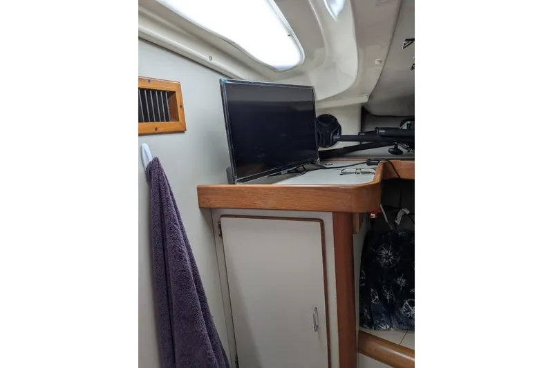 Slide: The Image of Interior of 1992 Luhrs Tournament 320 Convertible with TV and wooden cabinetry. - 18