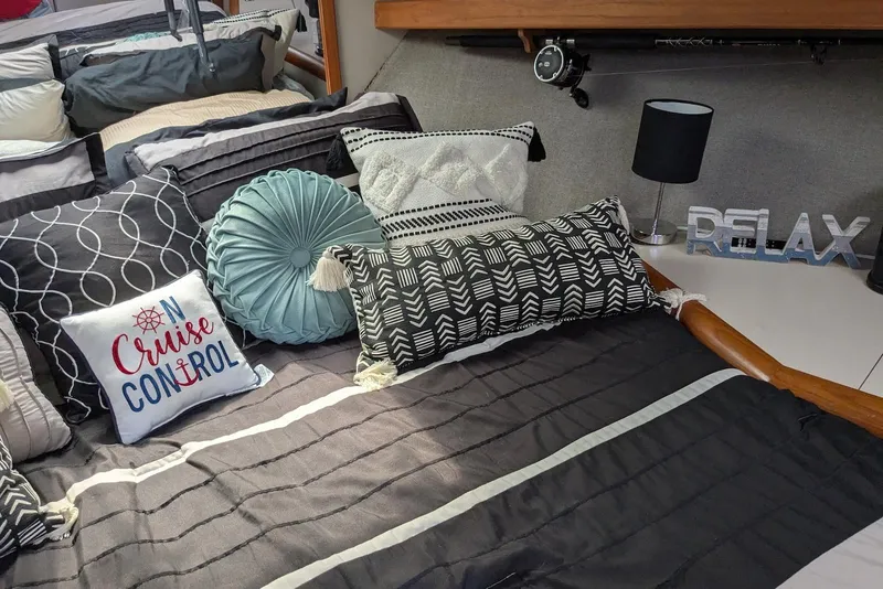 Slide: The Image of Cozy cabin interior of 1992 Luhrs Tournament 320 Convertible with decorative pillows and "Relax" sign. - 19