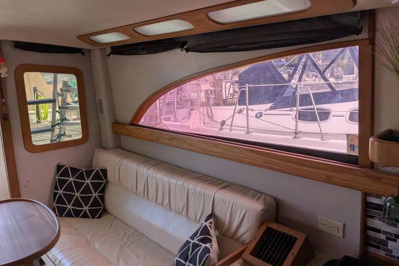 Slide: The Image of Interior of 1992 Luhrs Tournament 320 Convertible with sofa and marina view. - 26
