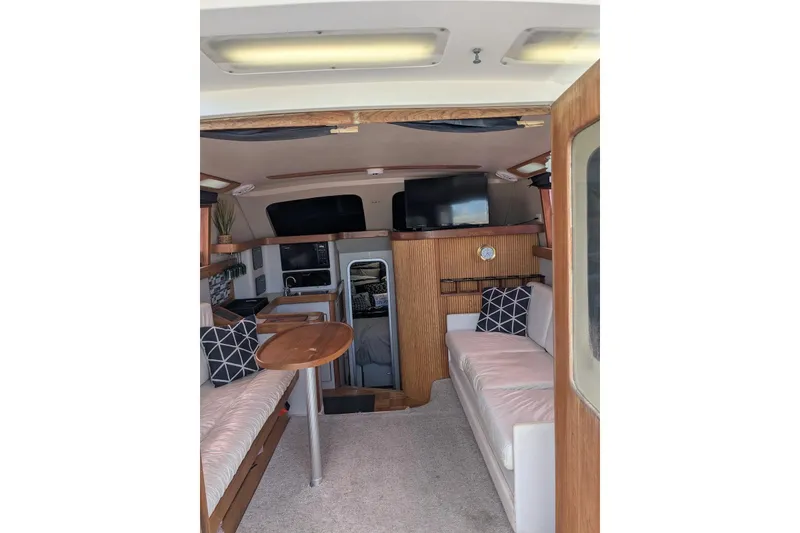 Slide: The Image of Interior of 1992 Luhrs Tournament 320 Convertible boat with seating, table, and TV. - 29
