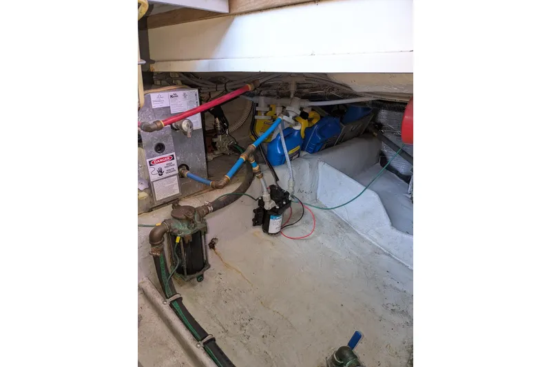 Slide: The Image of 1992 Luhrs Tournament 320 Convertible engine room with plumbing and equipment. - 32