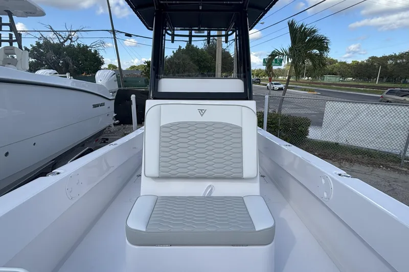 Slide: The Image of 2026 Twin Vee 22 Bay Cat boat interior with cushioned seating and sleek design. - 10