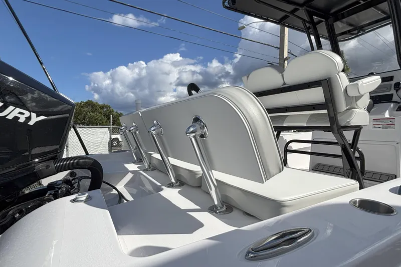 Slide: The Image of 2026 Twin Vee 22 Bay Cat boat interior with seating and Mercury engine. - 14