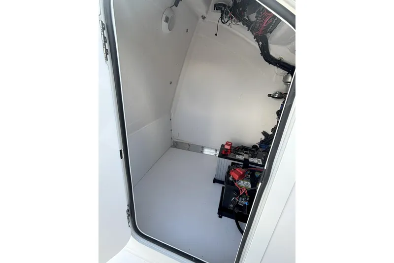 Slide: The Image of Interior view of 2026 Twin Vee 22 Bay Cat boat's storage compartment. - 15