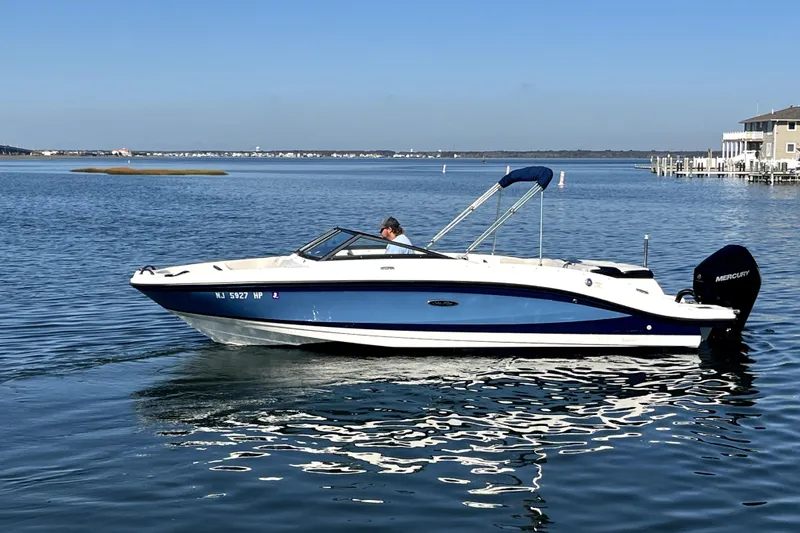 The Image of 2021 Sea Ray SPX 210 Outboard boat cruising on calm water. - 0