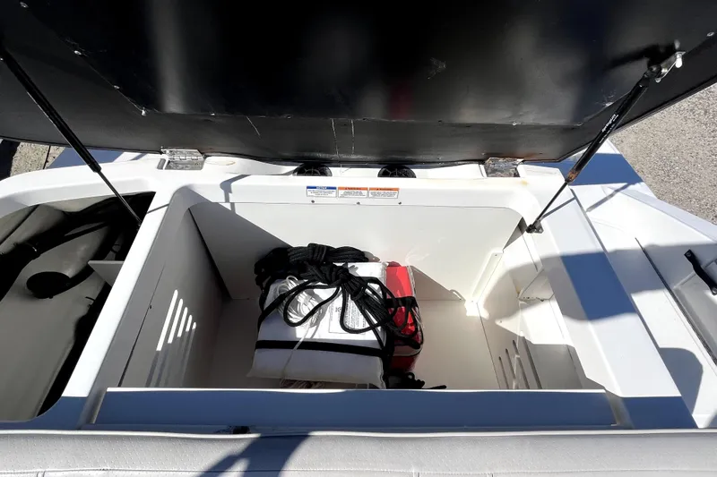 Slide: The Image of Open storage compartment in 2021 Sea Ray SPX 210 Outboard boat. - 14