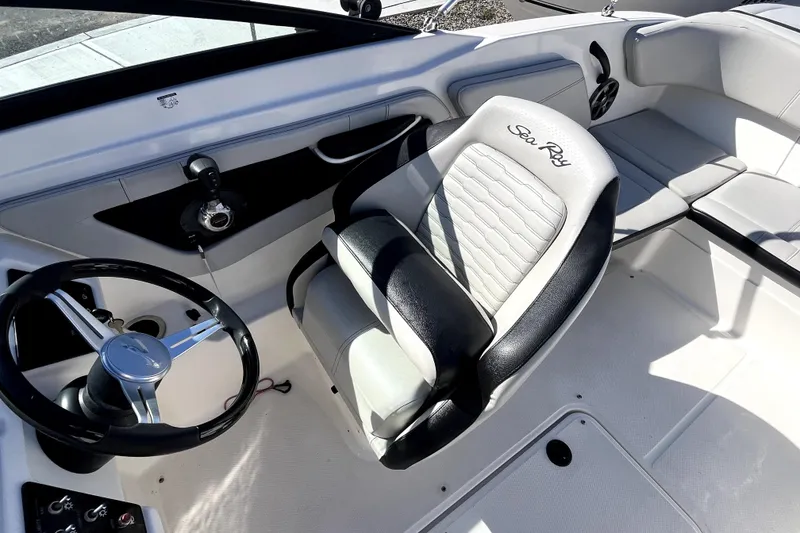 Slide: The Image of 2021 Sea Ray SPX 210 Outboard boat interior with steering wheel and captain's seat. - 17