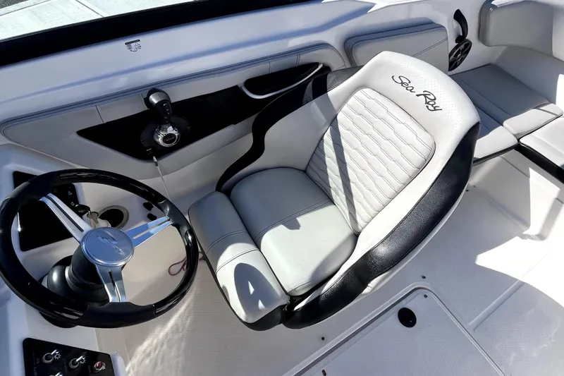 Slide: The Image of 2021 Sea Ray SPX 210 Outboard cockpit with steering wheel and comfortable seating. - 18