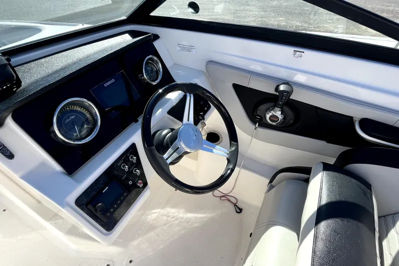 Slide: The Image of 2021 Sea Ray SPX 210 Outboard boat dashboard with steering wheel and controls. - 19