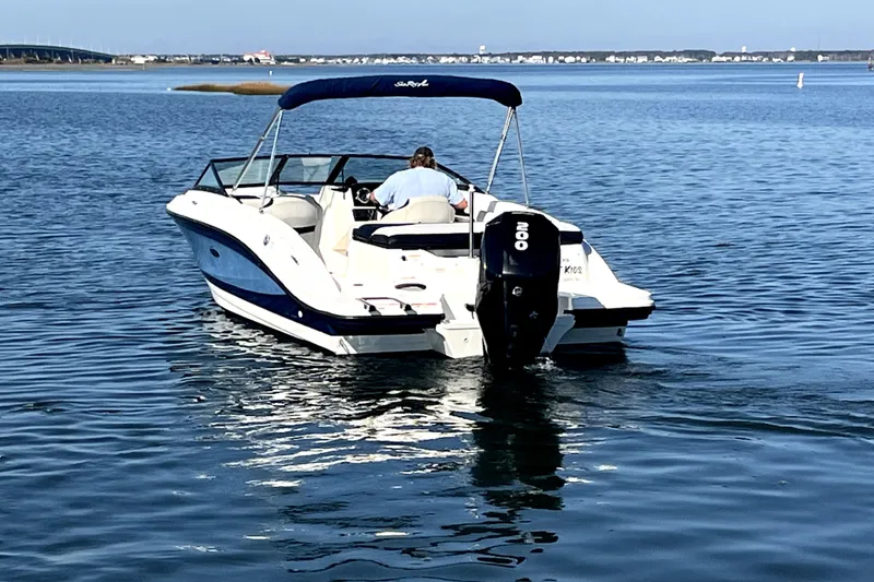 Slide: The Image of 2021 Sea Ray SPX 210 Outboard boat cruising on calm water. - 2