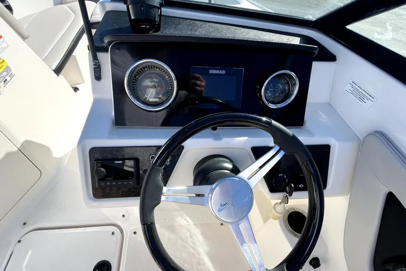 Slide: The Image of 2021 Sea Ray SPX 210 Outboard dashboard with steering wheel and instrument panel. - 20