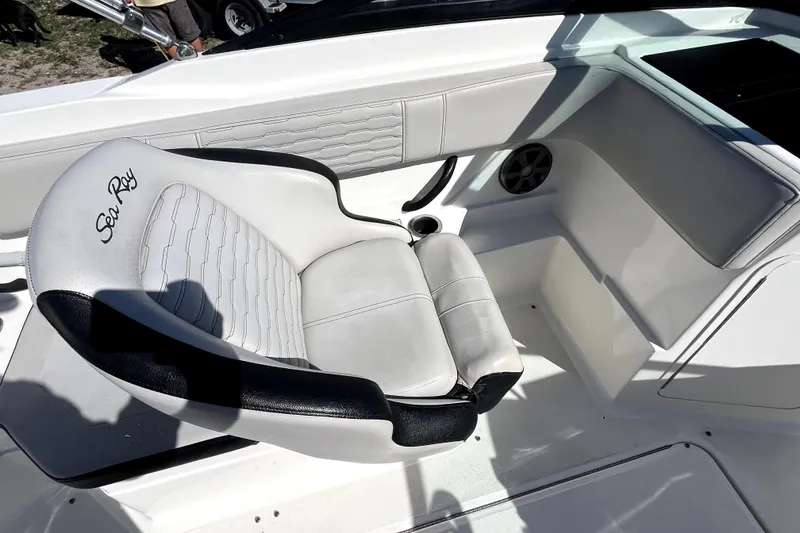 Slide: The Image of 2021 Sea Ray SPX 210 Outboard boat interior with white and black seating. - 21