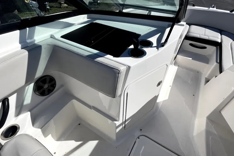 Slide: The Image of Interior of 2021 Sea Ray SPX 210 Outboard boat, featuring seating and cup holders. - 22