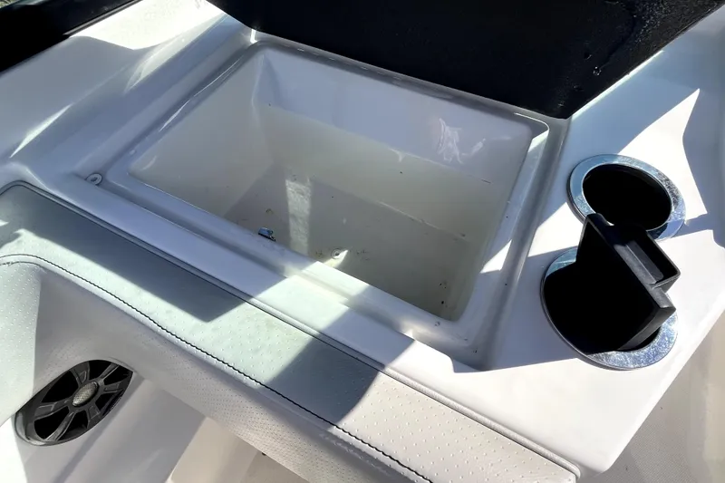 Slide: The Image of 2021 Sea Ray SPX 210 Outboard boat interior with storage compartment and cup holders. - 23