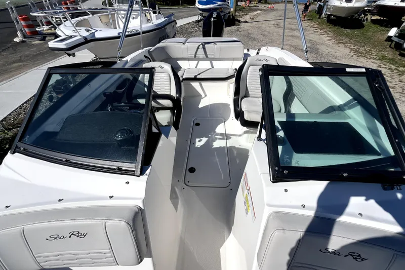 Slide: The Image of 2021 Sea Ray SPX 210 Outboard boat with open cockpit and seating, docked outdoors. - 27