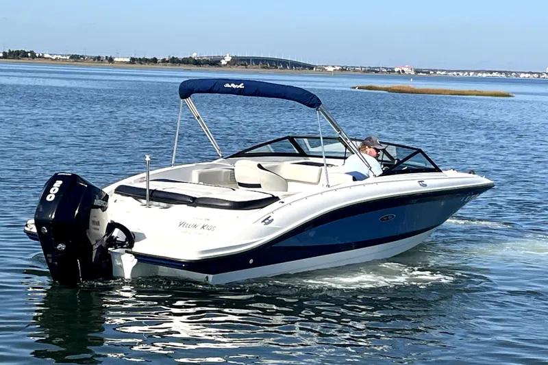 Slide: The Image of 2021 Sea Ray SPX 210 Outboard boat cruising on calm water. - 3