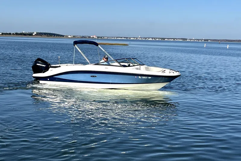 Slide: The Image of 2021 Sea Ray SPX 210 Outboard boat cruising on calm water. - 5