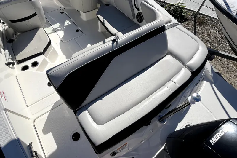 Slide: The Image of 2021 Sea Ray SPX 210 Outboard boat interior with cushioned seating and cup holders. - 8