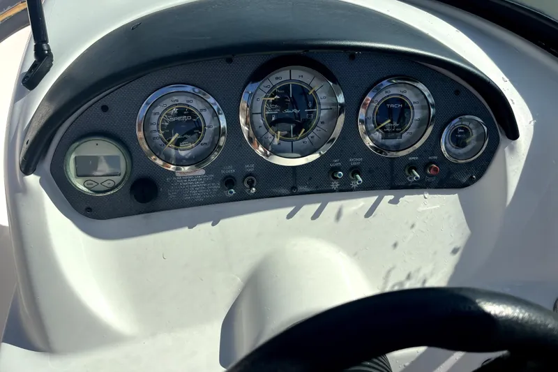 Slide: The Image of Dashboard of a 2012 Sea Ray 205 Sport boat with gauges and controls. - 10