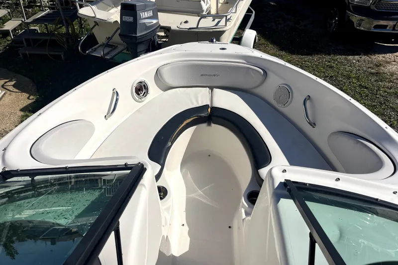 Slide: The Image of 2012 Sea Ray 205 Sport boat interior with seating and windshield. - 12
