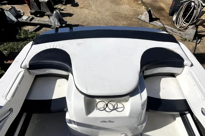 Slide: The Image of 2012 Sea Ray 205 Sport boat interior with cushioned seating and storage area. - 5