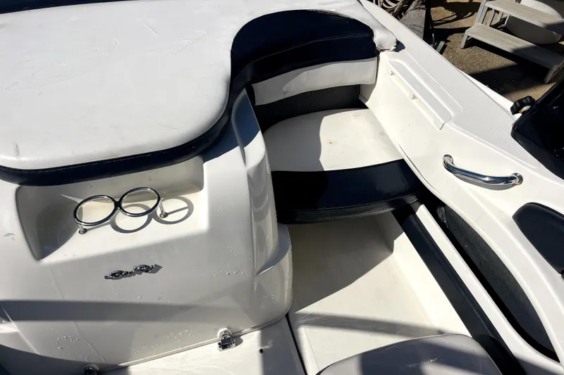 Slide: The Image of 2012 Sea Ray 205 Sport boat interior with seating and cup holders. - 7