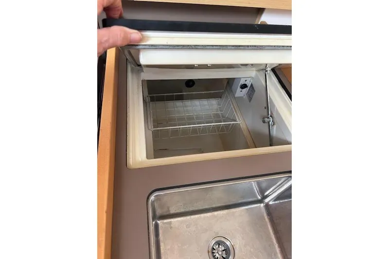 Slide: The Image of 2017 Beneteau Oceanis 38.1 sailboat cockpit with wooden deck and steering wheel at marina. - 22