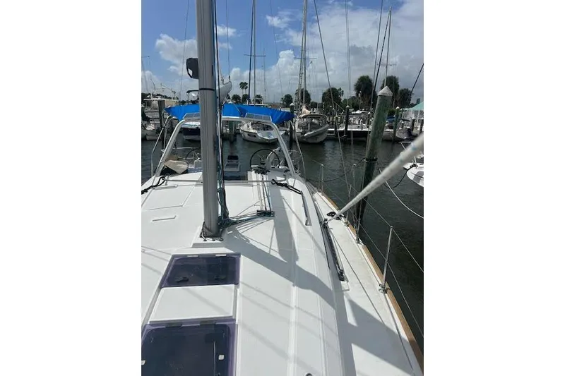 Slide: The Image of 2017 Beneteau Oceanis 38.1 sailboat cockpit with wooden deck and steering wheel at marina. - 23