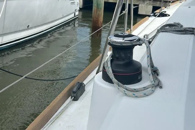 Slide: The Image of 2017 Beneteau Oceanis 38.1 sailboat with blue canopy docked at marina. - 26