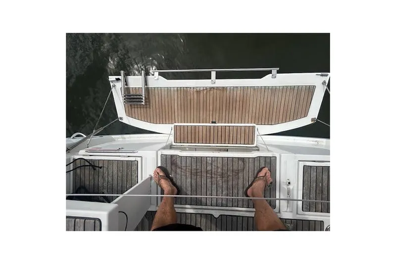 Slide: The Image of 2017 Beneteau Oceanis 38.1 sailboat docked, featuring dual steering wheels and spacious cockpit. - 33