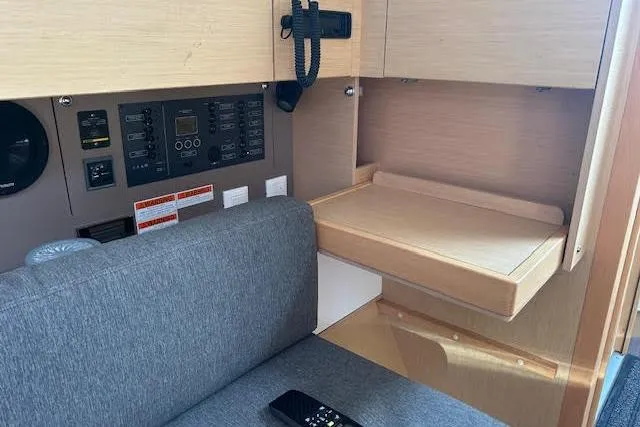 Slide: The Image of Beneteau Oceanis 38.1 2017 yacht kitchen sink with brown countertop and wooden accents. - 6