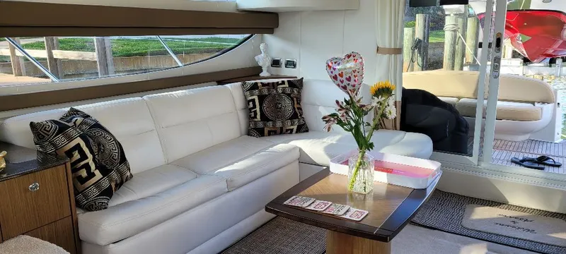Slide: The Image of Luxurious interior of 2016 Meridian 391 Sedan yacht with white sofa and floral decor. - 11