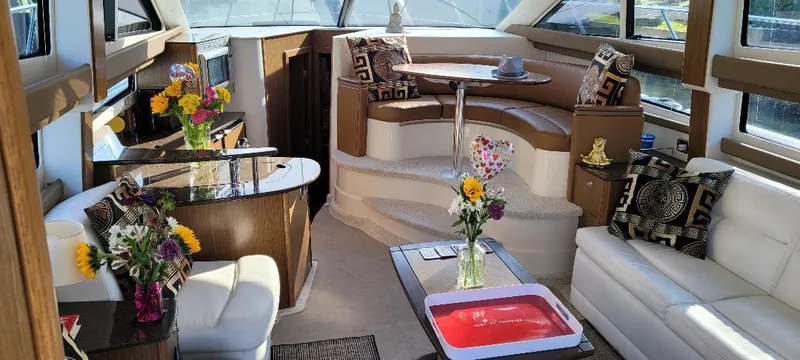 Slide: The Image of Luxurious interior of a 2016 Meridian 391 Sedan yacht with elegant seating and floral decor. - 15