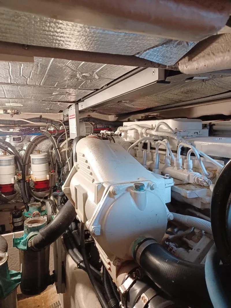 Slide: The Image of Engine room of a 2016 Meridian 391 Sedan yacht, showcasing mechanical components and piping. - 19